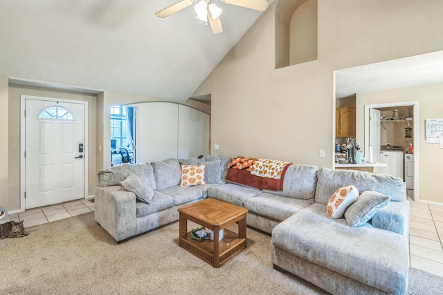 living room with light carpet, washing machine and dryer, high vaulted ceiling, and ceiling fan