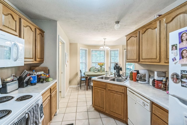 kitchen featuring light tile patterned flooring, sink, white appliances, decorative light fixtures, and a notable chandelier