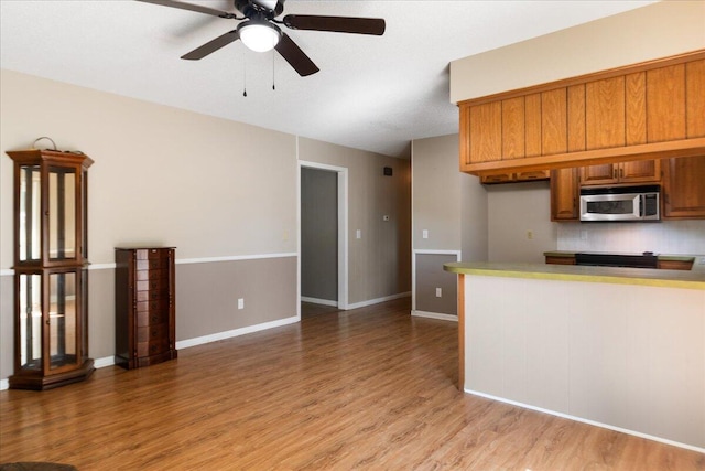 kitchen with ceiling fan and light hardwood / wood-style floors