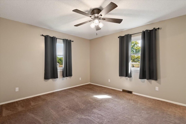 spare room with carpet floors, a textured ceiling, and ceiling fan