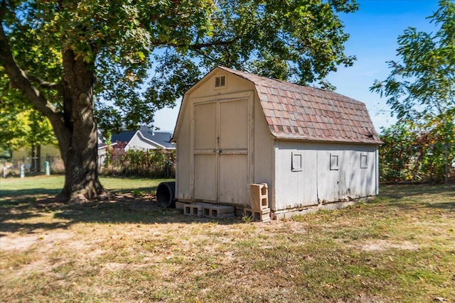 view of outbuilding featuring a lawn