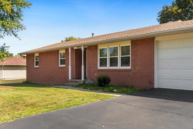 single story home featuring a front yard and a garage