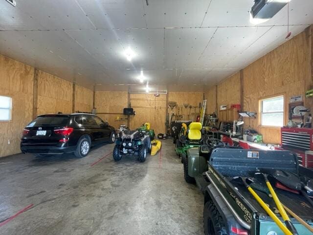 garage featuring wooden walls and a workshop area