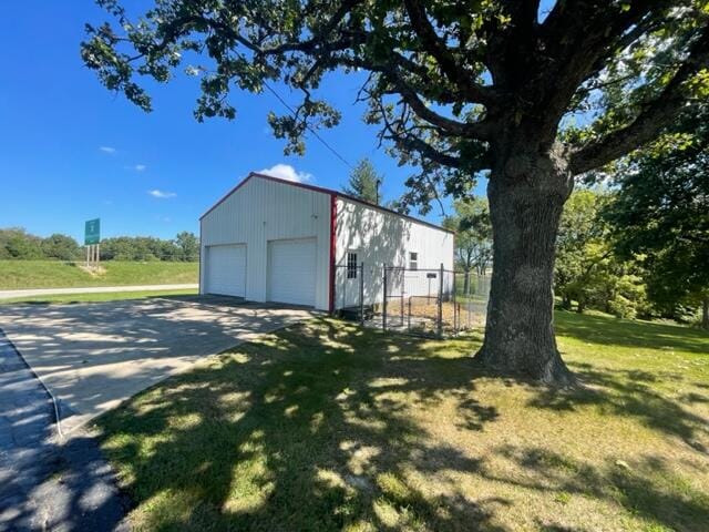 garage featuring a lawn