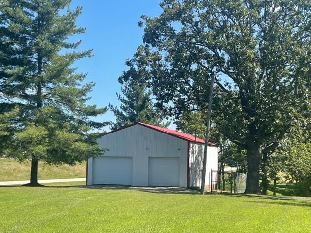 view of outbuilding with a garage and a lawn