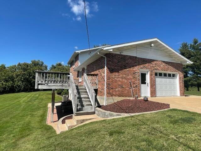 view of home's exterior with a garage and a lawn