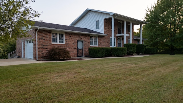 view of front of home with a garage and a front lawn