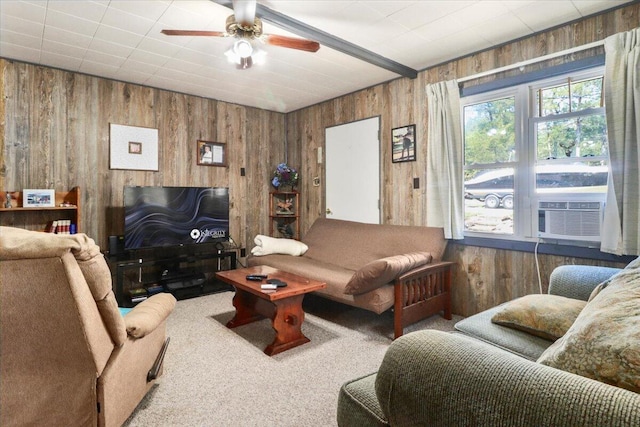 carpeted living room with wooden walls, cooling unit, and ceiling fan