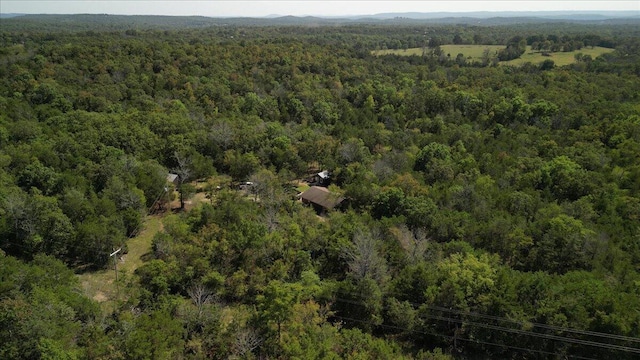 drone / aerial view featuring a wooded view