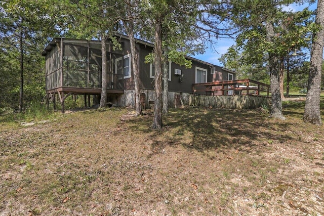 view of yard with a sunroom and a deck