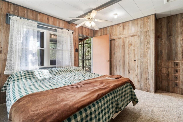 carpeted bedroom with wood walls