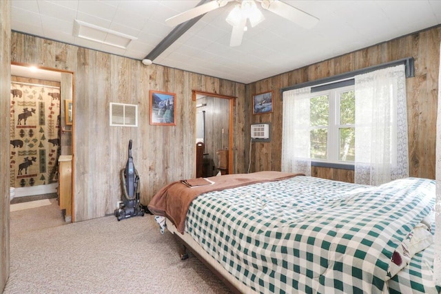 bedroom featuring a wall mounted AC, carpet flooring, wood walls, and visible vents