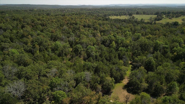 bird's eye view featuring a wooded view