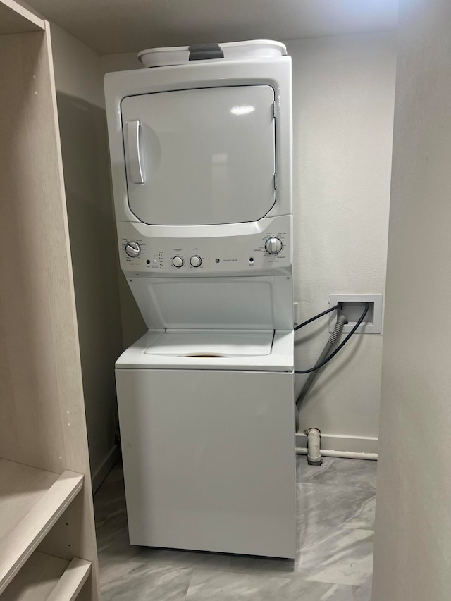 laundry room with stacked washer / drying machine