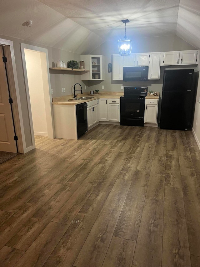 kitchen with black appliances, hanging light fixtures, sink, and white cabinets