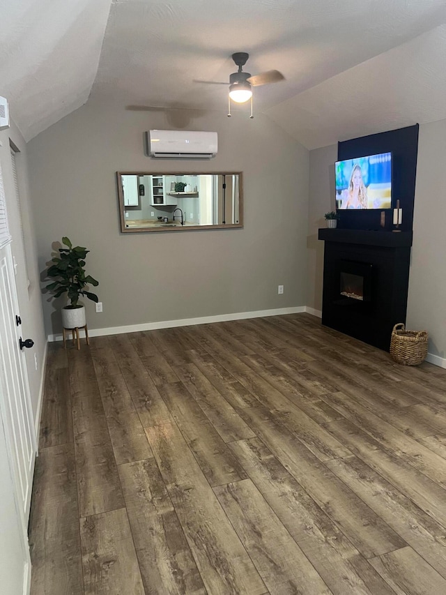 living room featuring lofted ceiling, an AC wall unit, hardwood / wood-style floors, and ceiling fan