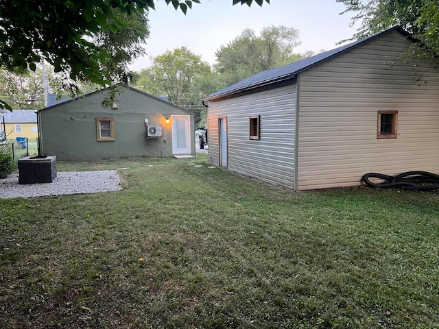 exterior space with a lawn and central AC unit