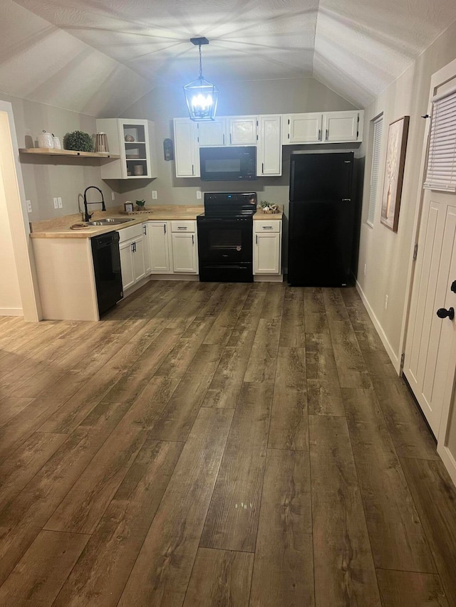 kitchen featuring white cabinets, decorative light fixtures, sink, and black appliances