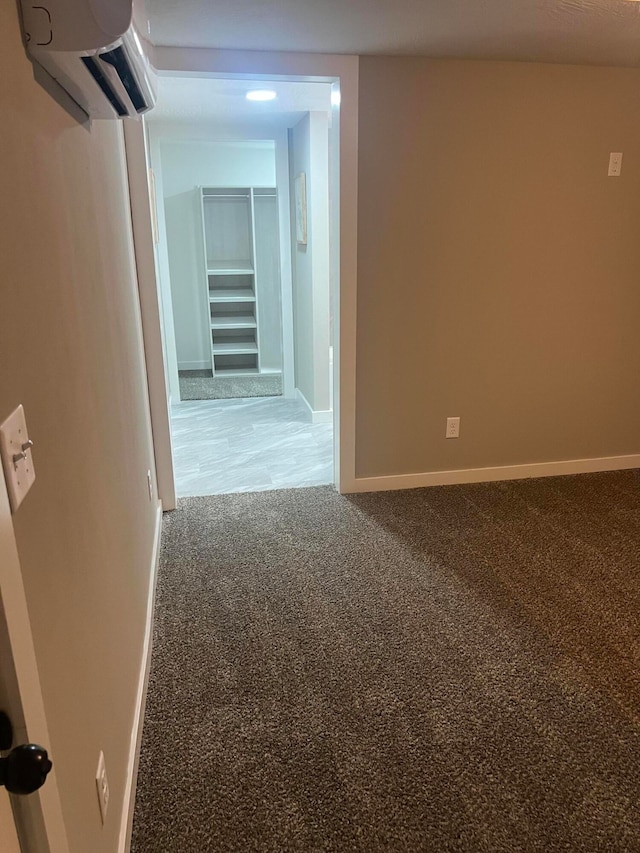 interior space featuring carpet and a wall mounted AC