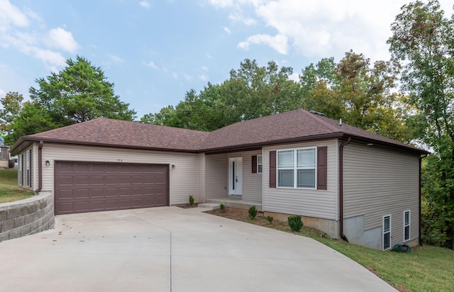 single story home featuring a garage and a front yard