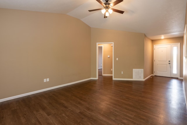 interior space with ceiling fan, vaulted ceiling, and dark hardwood / wood-style floors