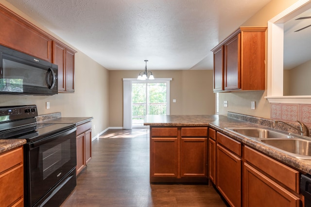 kitchen featuring black appliances, sink, dark hardwood / wood-style flooring, kitchen peninsula, and decorative light fixtures