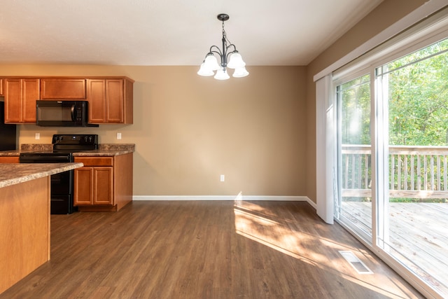 kitchen with decorative light fixtures, a chandelier, dark hardwood / wood-style flooring, and black appliances