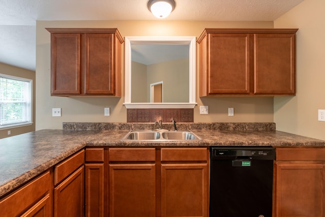 kitchen featuring a textured ceiling, sink, and dishwasher