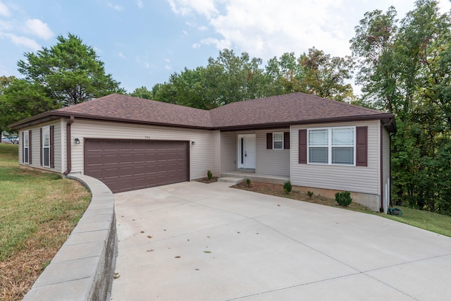 ranch-style house featuring a garage and a front lawn