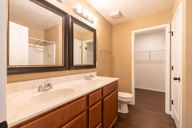 bathroom with vanity, toilet, and hardwood / wood-style flooring