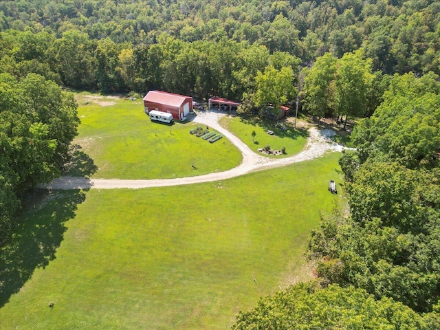 bird's eye view with a wooded view