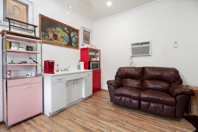 living room with crown molding, light wood-style floors, and a wall mounted AC