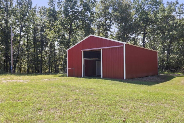 view of outbuilding featuring a lawn