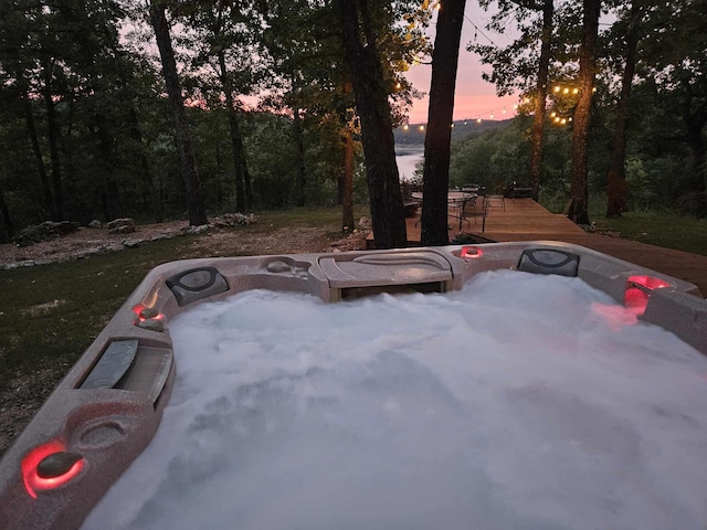 exterior space featuring a deck and a hot tub