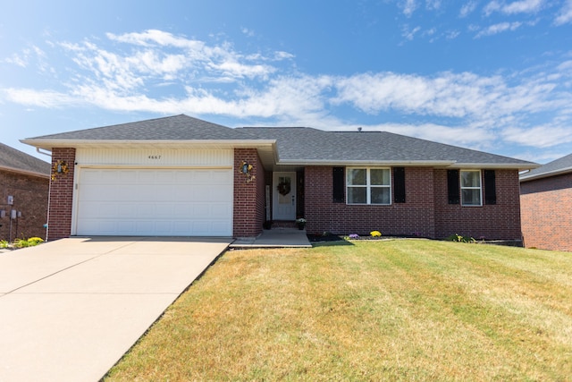 single story home with a garage and a front lawn