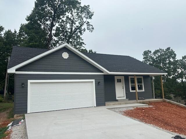 ranch-style home featuring a porch and a garage