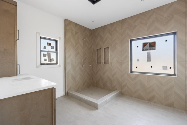 bathroom with vanity, tile patterned floors, and tiled shower