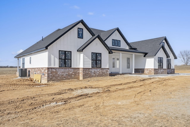 modern farmhouse style home with central AC and covered porch