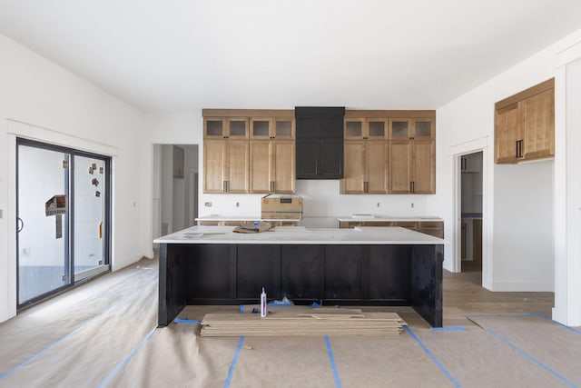 kitchen with a kitchen island with sink and light hardwood / wood-style floors