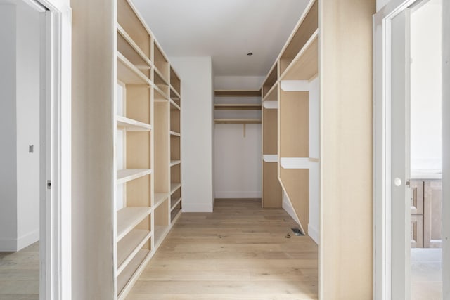 spacious closet featuring light hardwood / wood-style floors