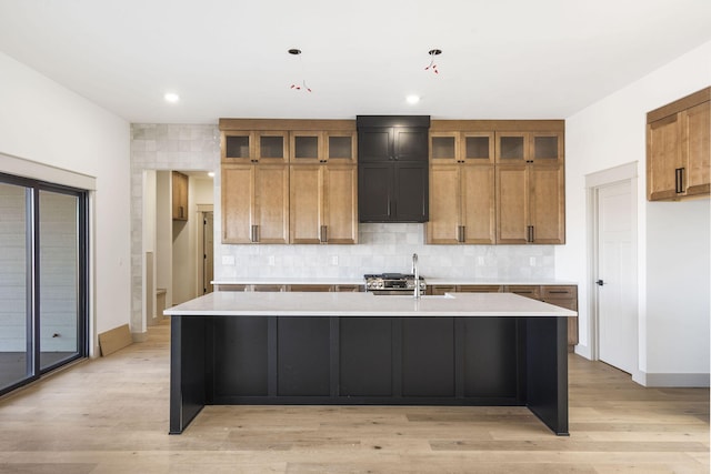 kitchen featuring tasteful backsplash, brown cabinetry, and light countertops