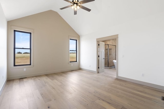 spare room featuring ceiling fan, high vaulted ceiling, light wood-style flooring, visible vents, and baseboards