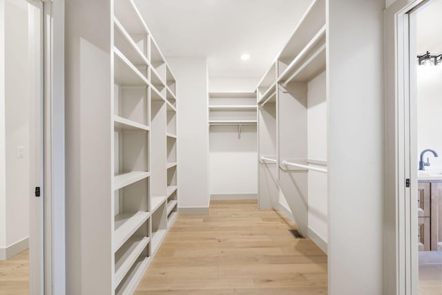 walk in closet featuring light wood-style floors and visible vents