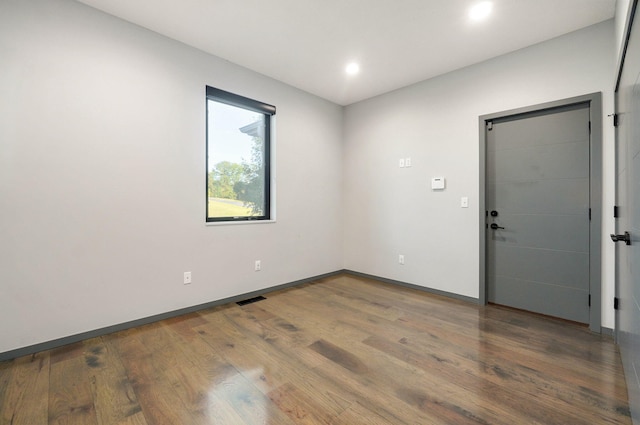 unfurnished room with hardwood / wood-style floors