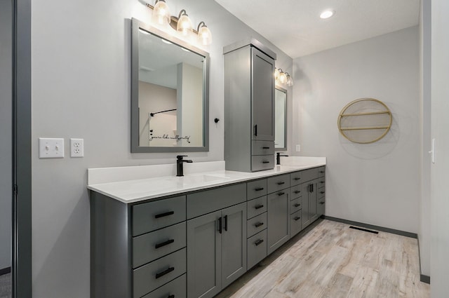 bathroom featuring wood-type flooring and vanity