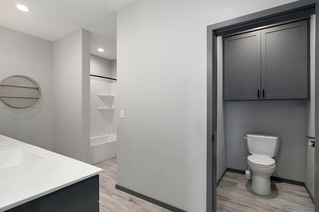 bathroom with vanity, hardwood / wood-style floors, and toilet