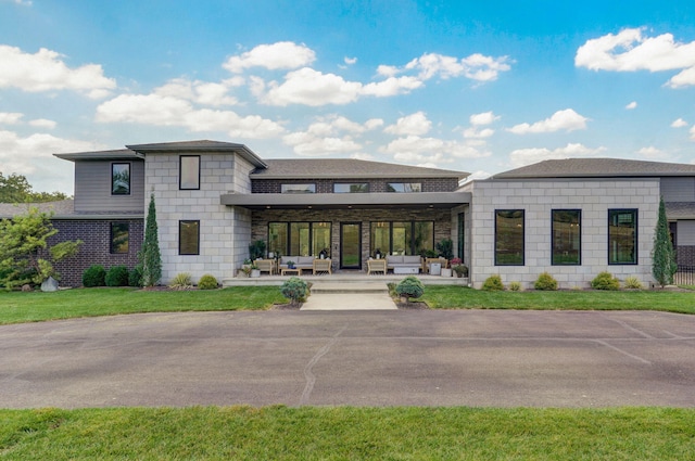 exterior space featuring an outdoor hangout area and a patio