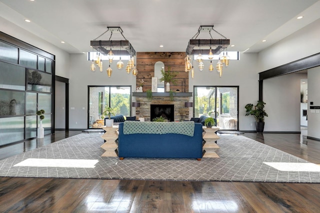 living room with a notable chandelier, a towering ceiling, and a wealth of natural light