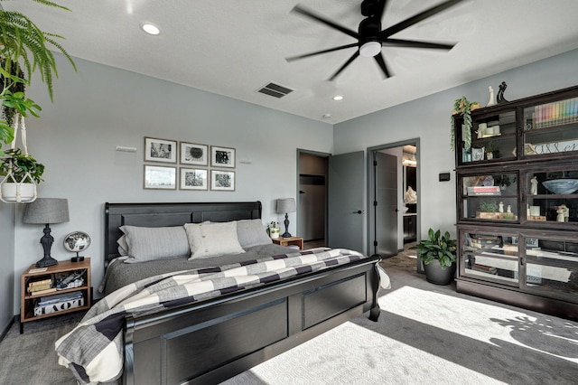 carpeted bedroom featuring ceiling fan, a textured ceiling, and ensuite bathroom