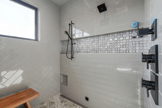 bathroom featuring tile walls and a tile shower